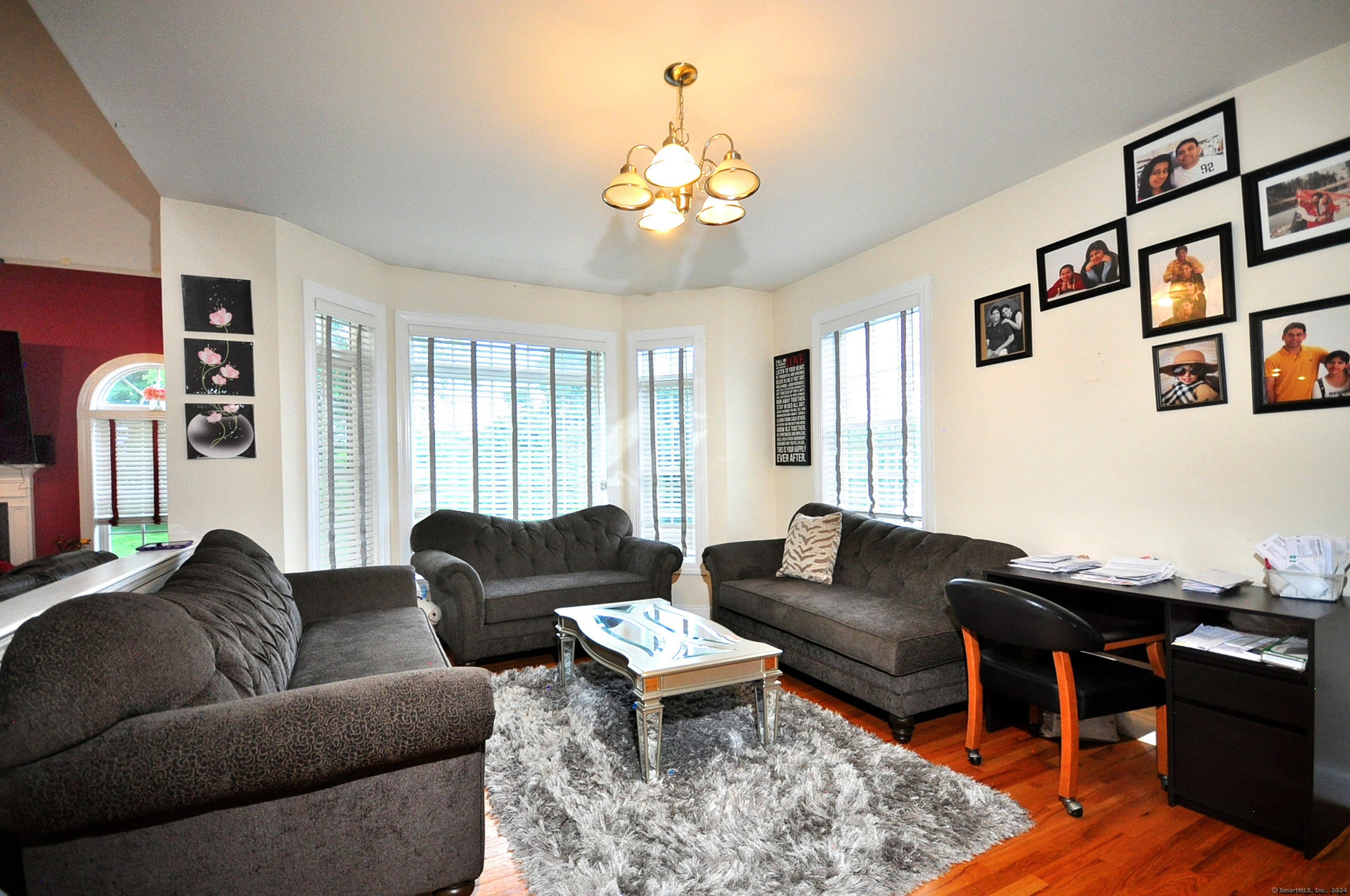 3 Maplecrest Lane Hamden, CT 06514 - Photo 17 of 40 a living room with furniture a rug and a chandelier