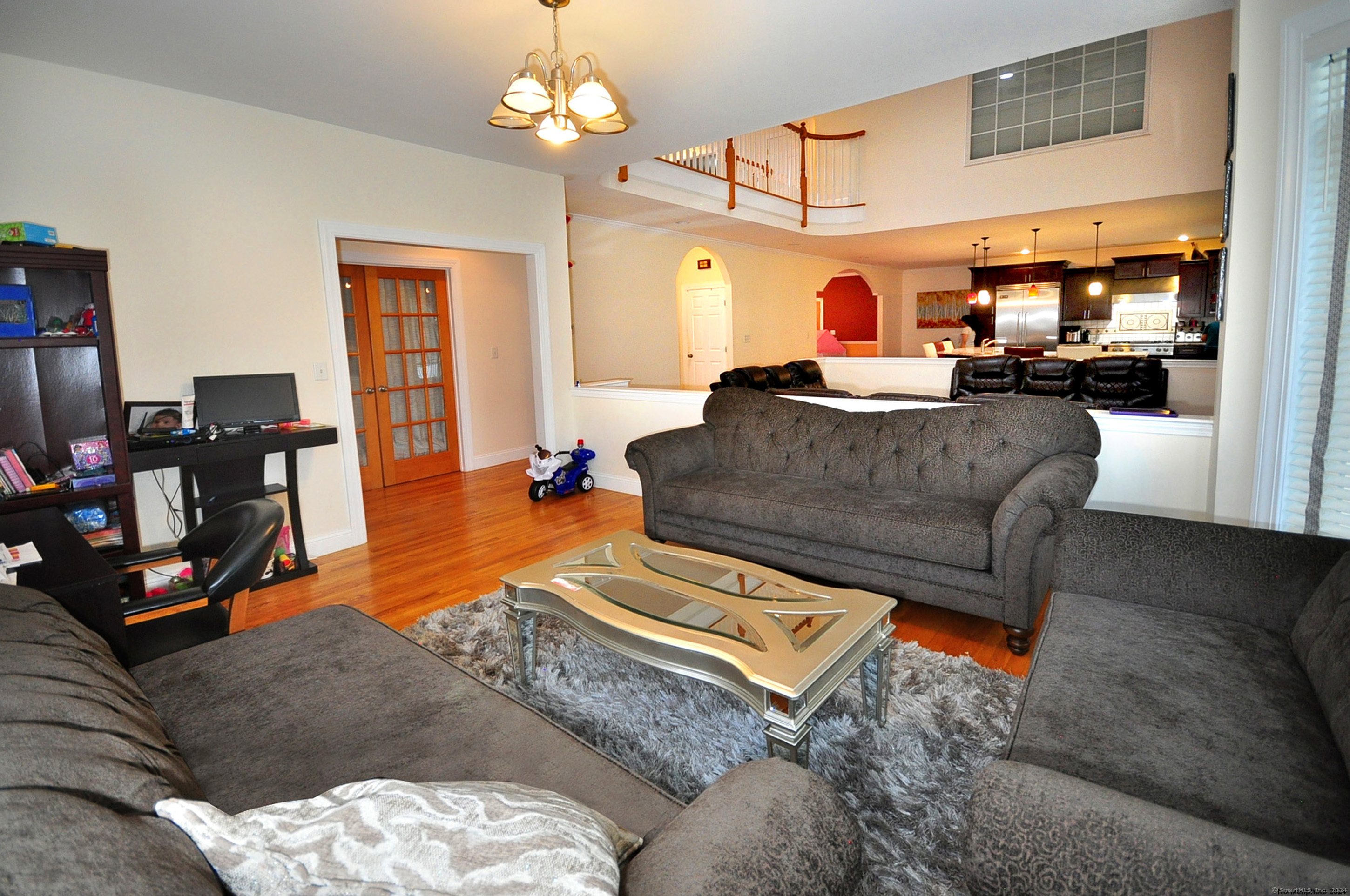 3 Maplecrest Lane Hamden, CT 06514 - Photo 18 of 40 a living room with furniture and a chandelier