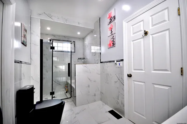 a bathroom with a glass shower door