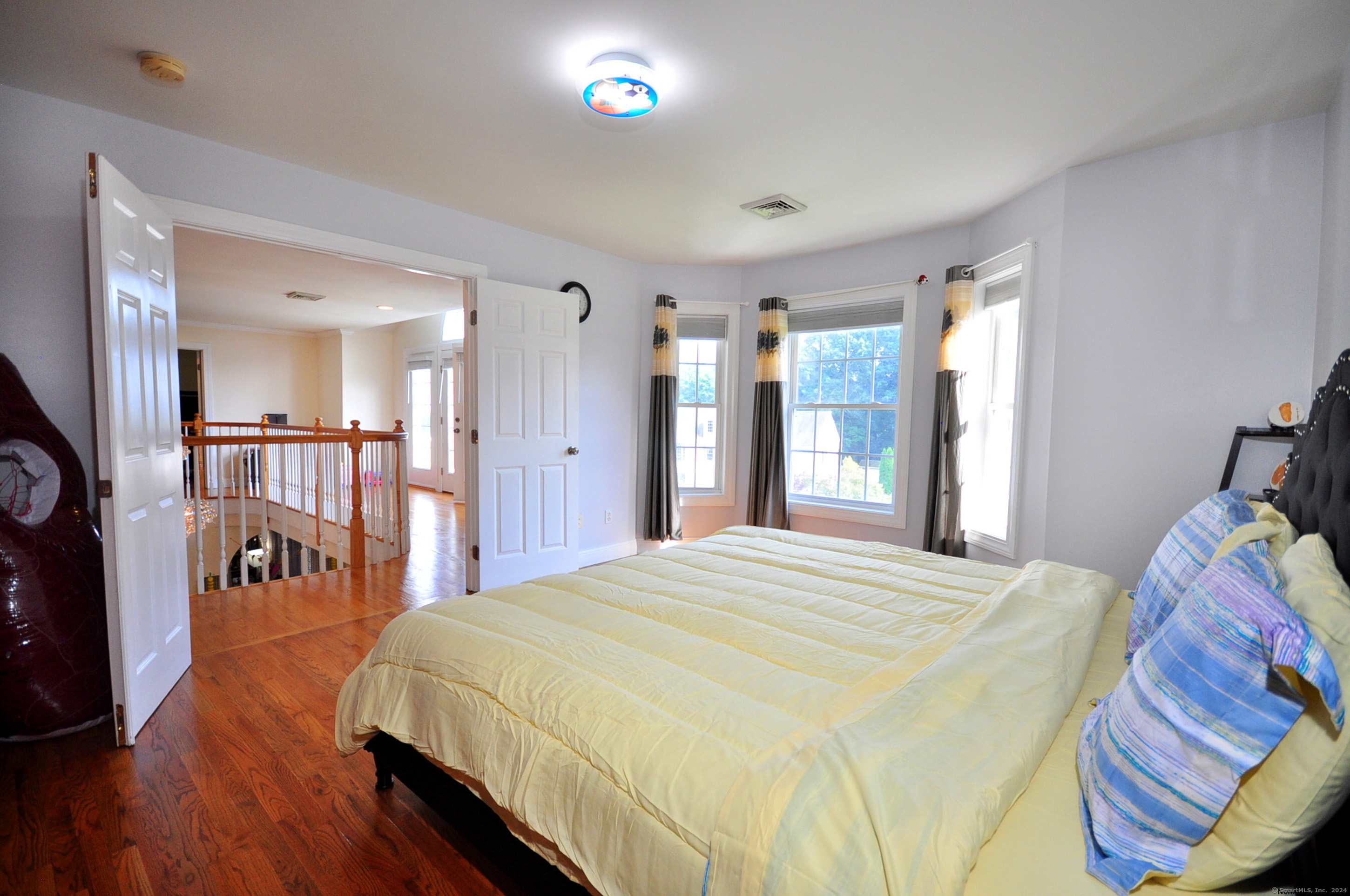 3 Maplecrest Lane Hamden, CT 06514 - Photo 32 of 40 a bed room with a bed and a large mirror