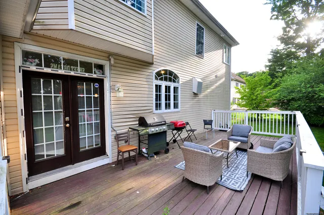 a view of a deck with couches and wooden floor