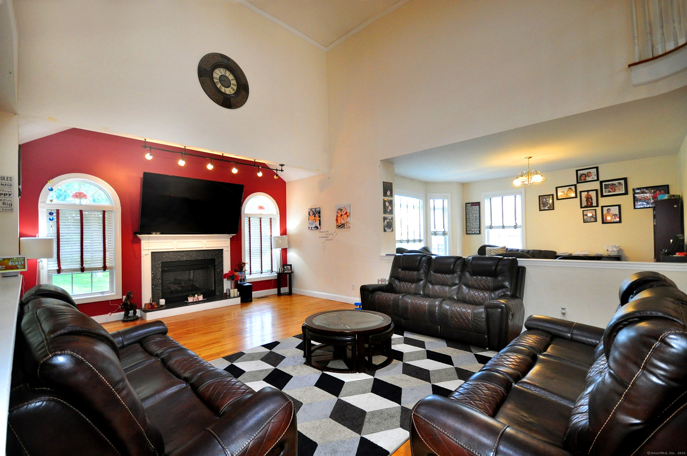 3 Maplecrest Lane Hamden, CT 06514 - Photo 7 of 40 a living room with furniture a fireplace and a flat screen tv