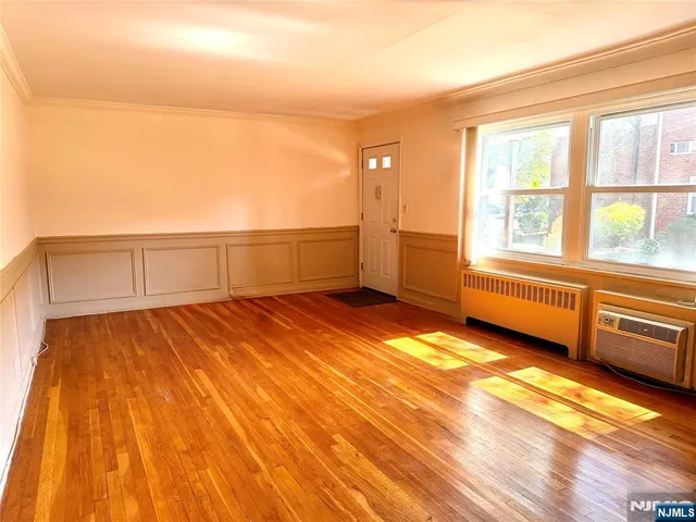 a view of a room with wooden floor