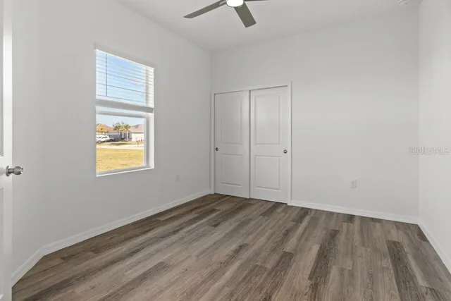wooden floor in an empty room with a window