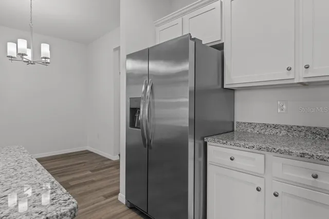 a kitchen with cabinets and stainless steel appliances