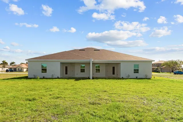 a big house with a big yard and large trees
