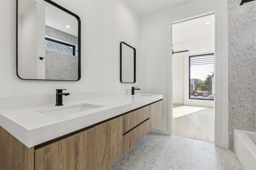 5635 Matalee Avenue Dallas, TX 75206 - Photo 23 of 27 a bathroom with a double vanity sink and mirror