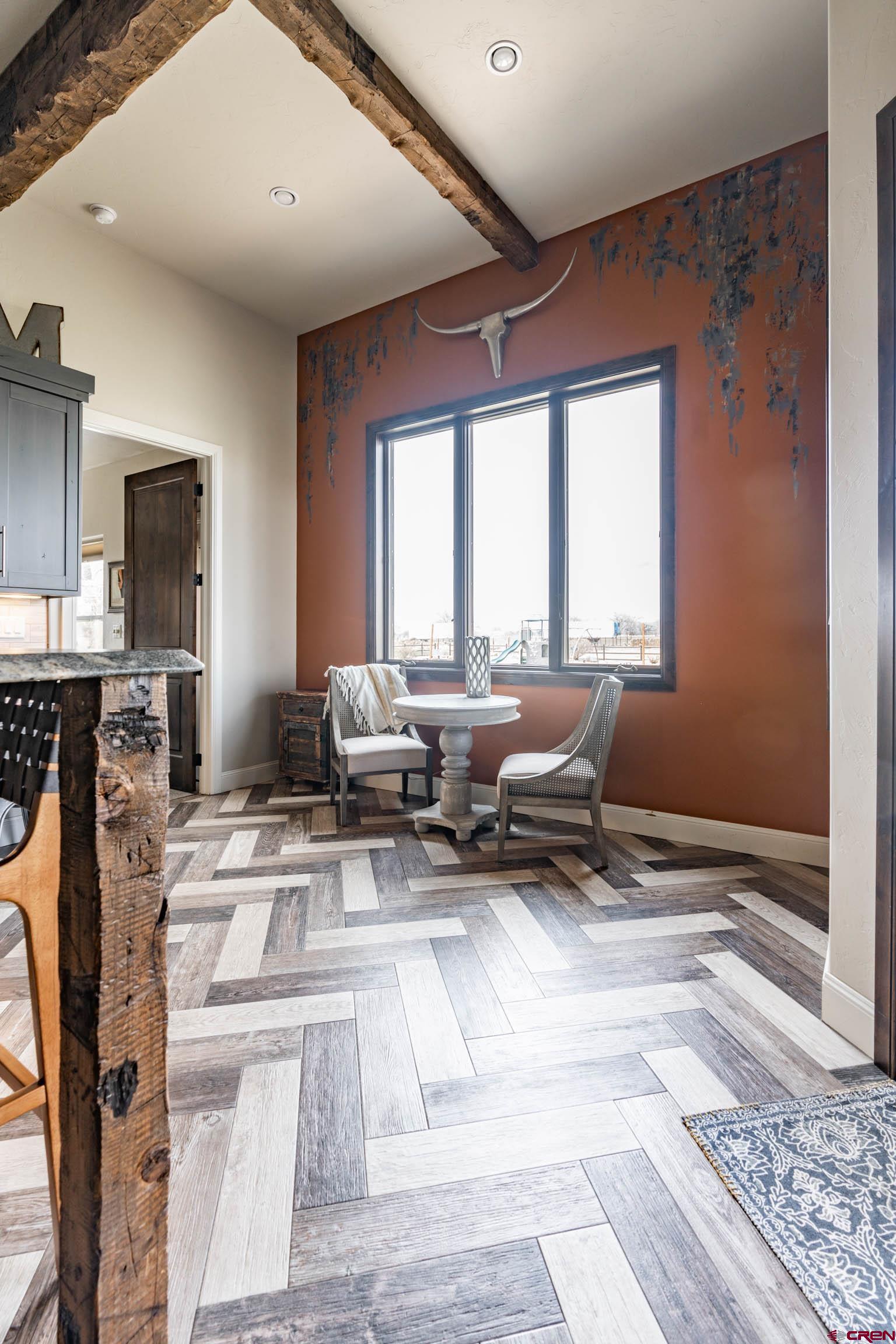 1988 J Road Fruita, CO 81521 - Photo 8 of 35 a living room with furniture a large window and a fireplace