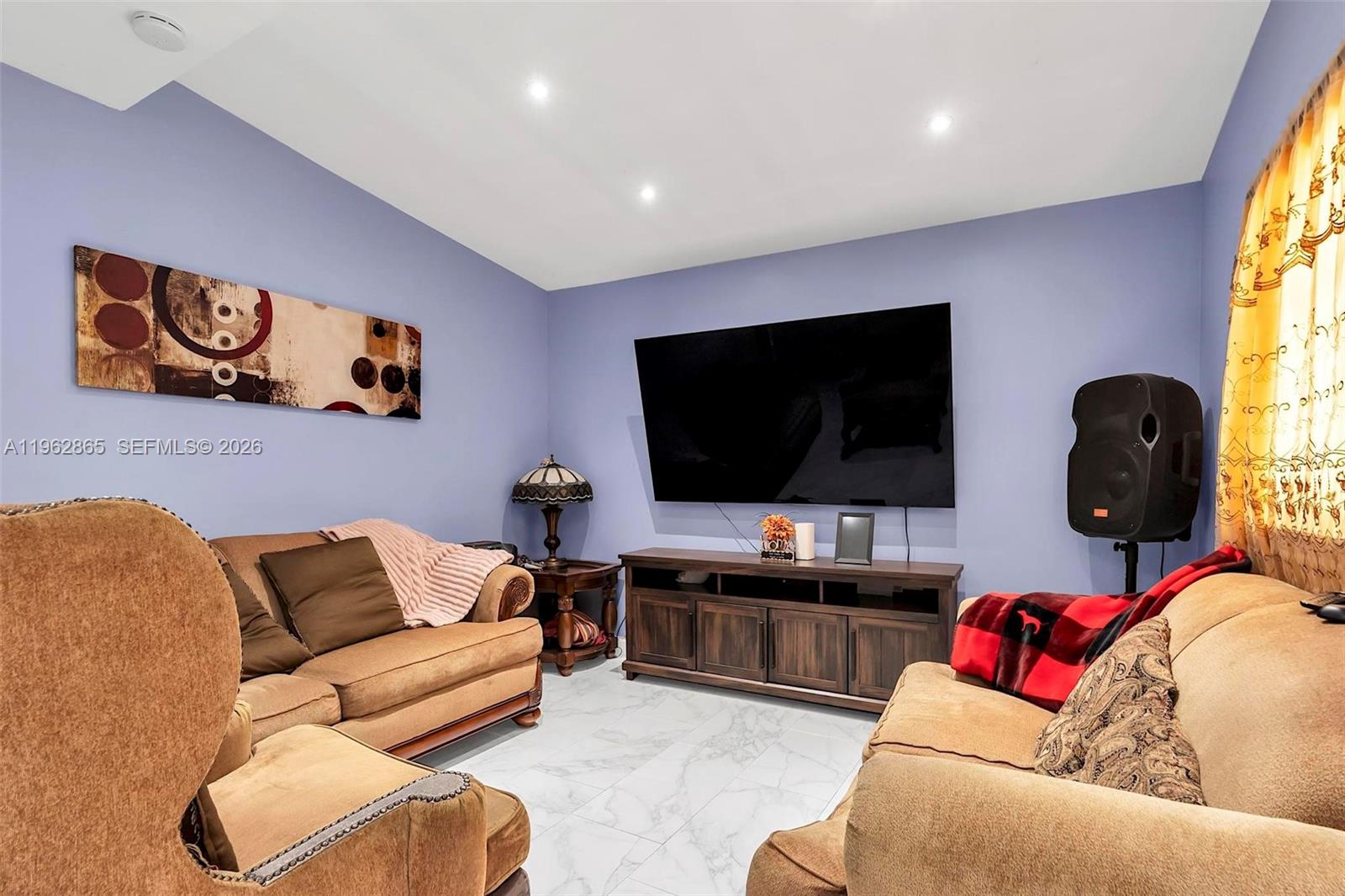 12201 Southwest 194th Terrace Miami, FL 33177 - Photo 12 of 34 a living room with furniture and a flat screen tv