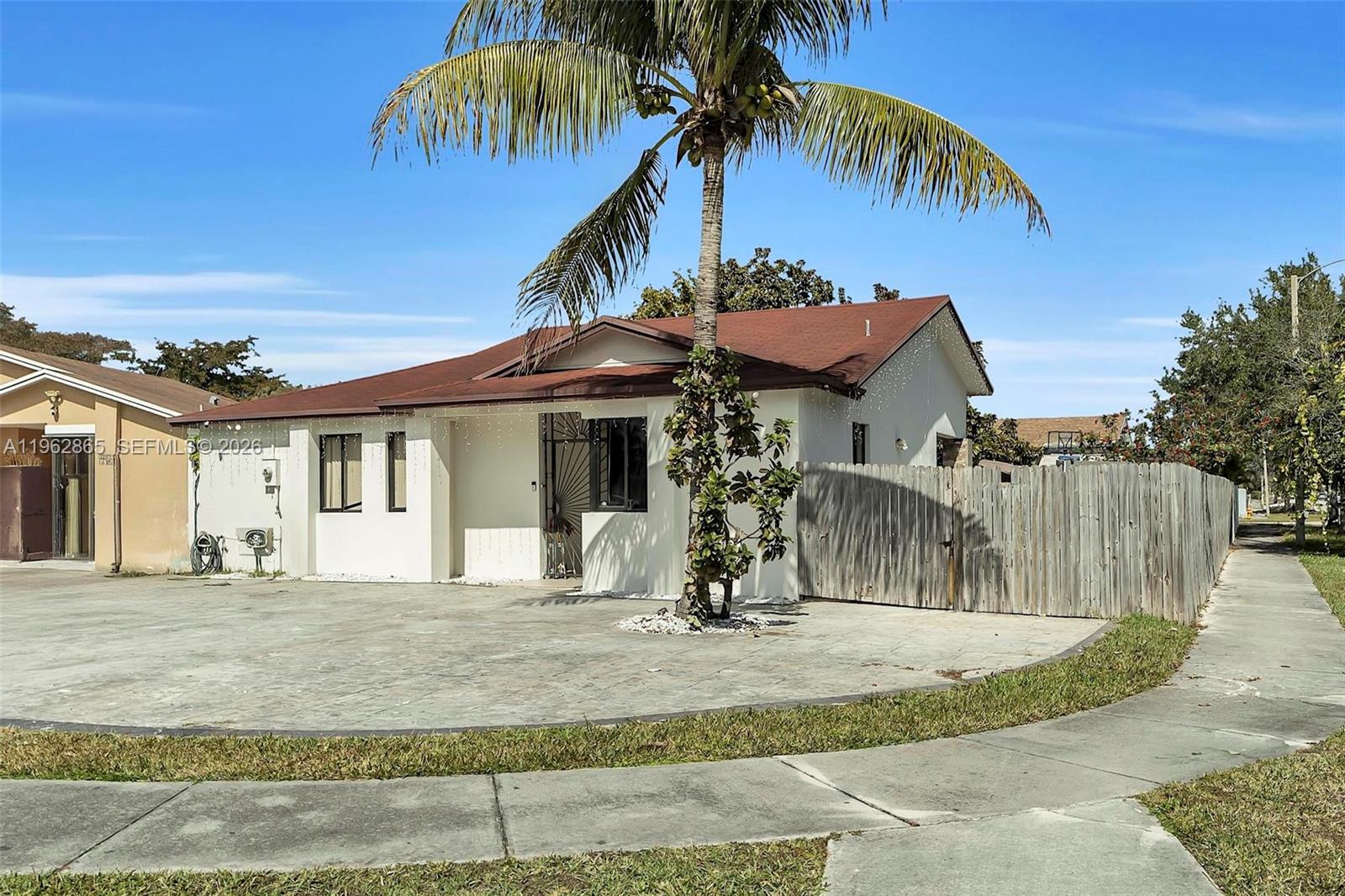 12201 Southwest 194th Terrace Miami, FL 33177 - Photo 2 of 34 a view of a house with a yard
