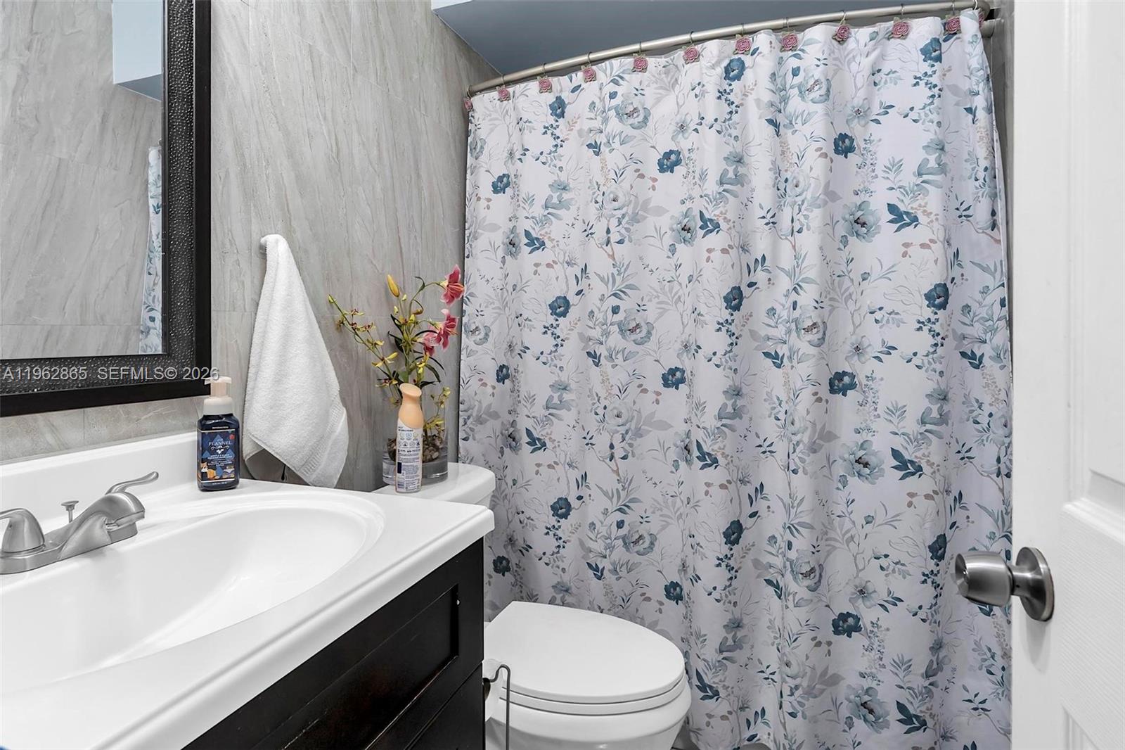 12201 Southwest 194th Terrace Miami, FL 33177 - Photo 21 of 34 a bathroom with a sink toilet and mirror