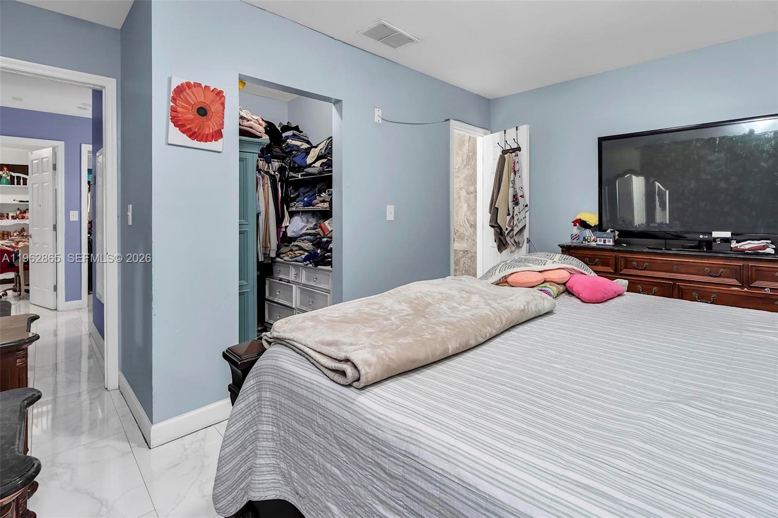 12201 Southwest 194th Terrace Miami, FL 33177 - Photo 23 of 34 a bedroom with a bed and a flat screen tv