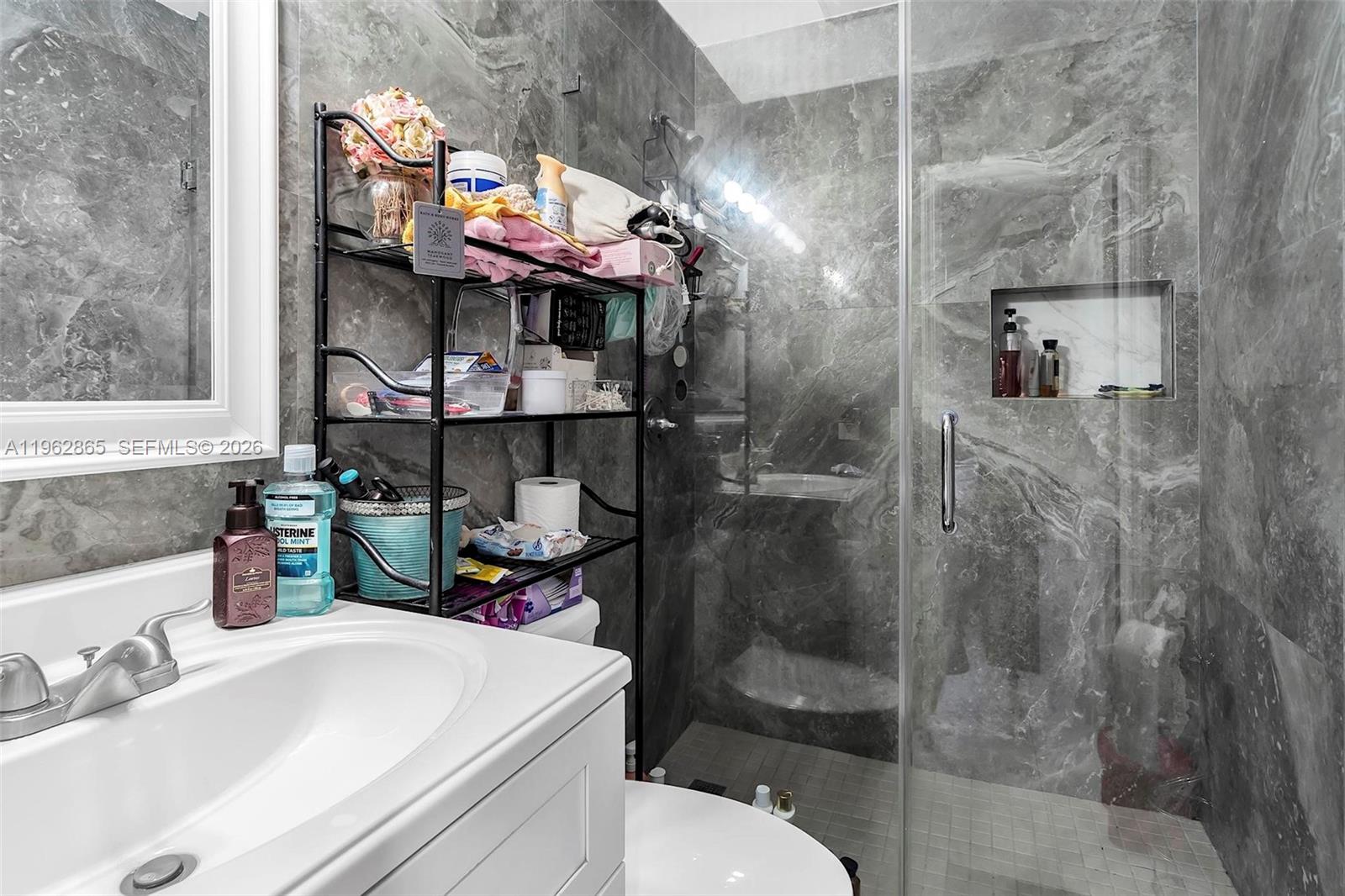 12201 Southwest 194th Terrace Miami, FL 33177 - Photo 25 of 34 a bathroom with a sink a toilet and shower