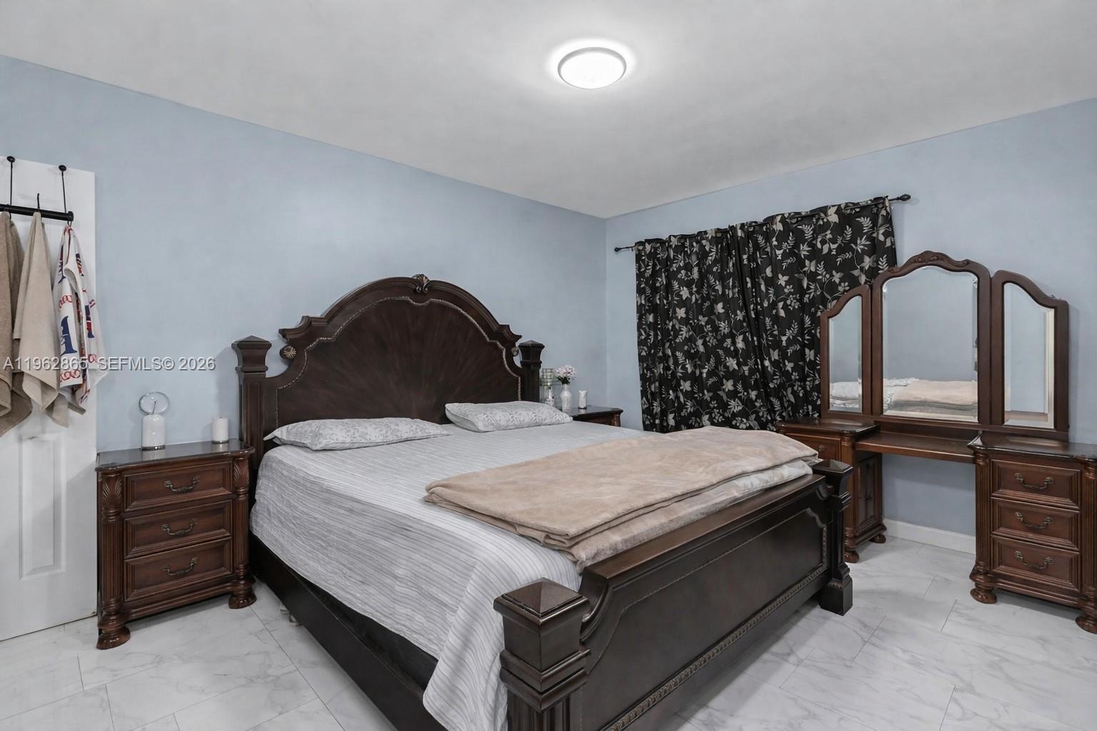 12201 Southwest 194th Terrace Miami, FL 33177 - Photo 26 of 34 a bedroom with a bed and a dresser