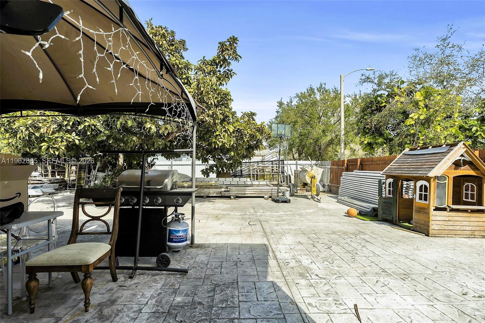12201 Southwest 194th Terrace Miami, FL 33177 - Photo 27 of 34 a view of a patio with table and chairs and potted plants