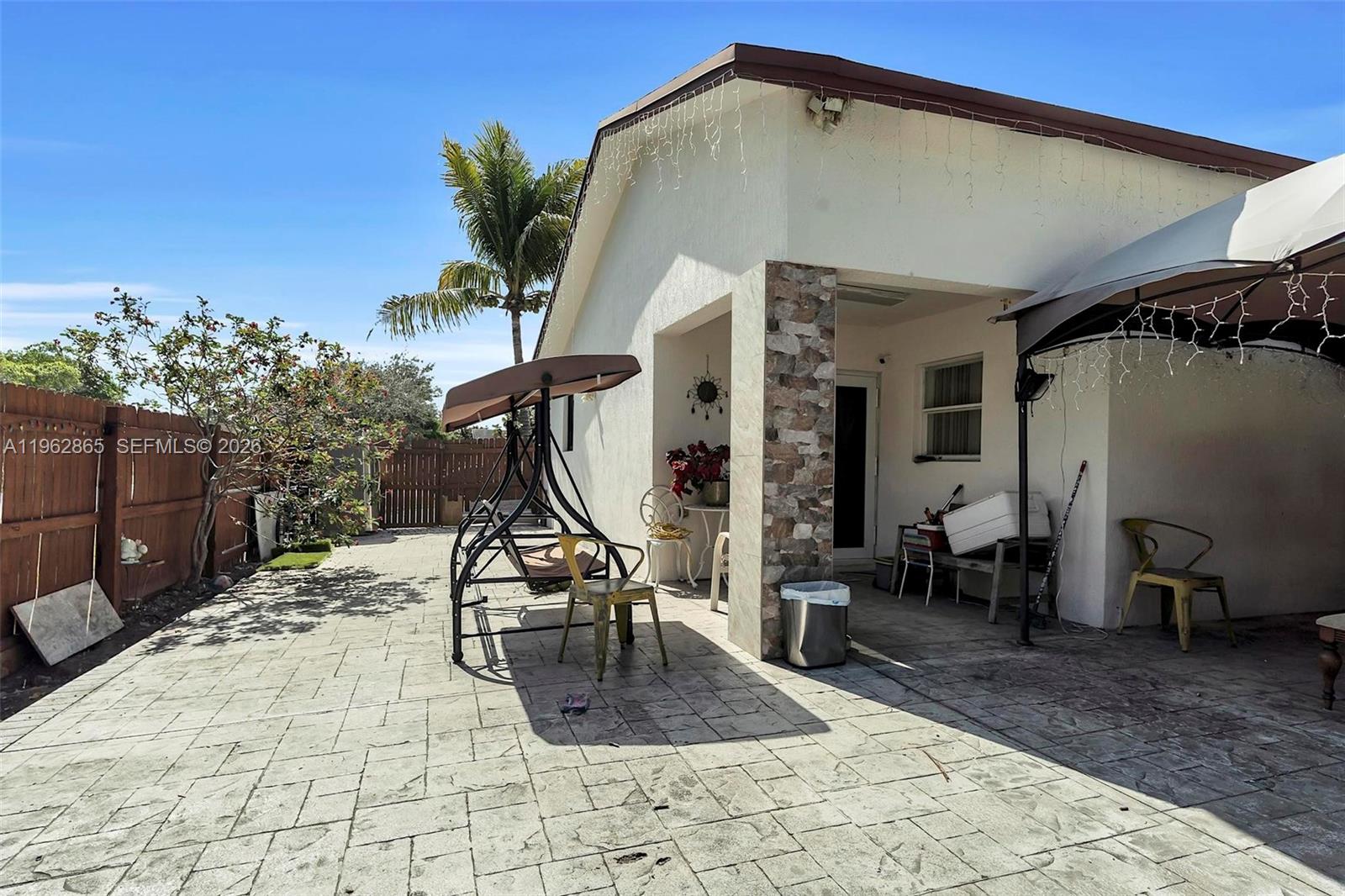 12201 Southwest 194th Terrace Miami, FL 33177 - Photo 32 of 34 a view of a dinning tables and chairs in patio