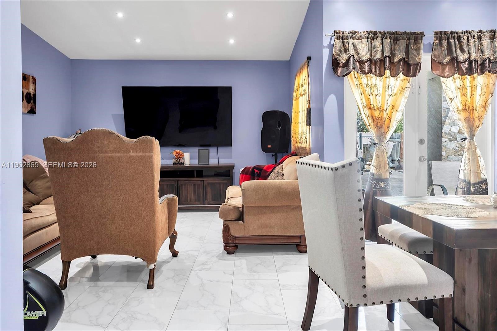 12201 Southwest 194th Terrace Miami, FL 33177 - Photo 10 of 34 a living room with furniture and a flat screen tv