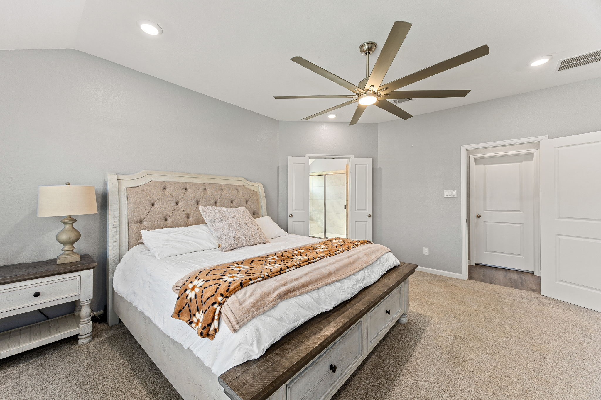 23002 Blackstone Park Road Katy, TX 77493 - Photo 19 of 36 a bedroom with a bed and a ceiling fan