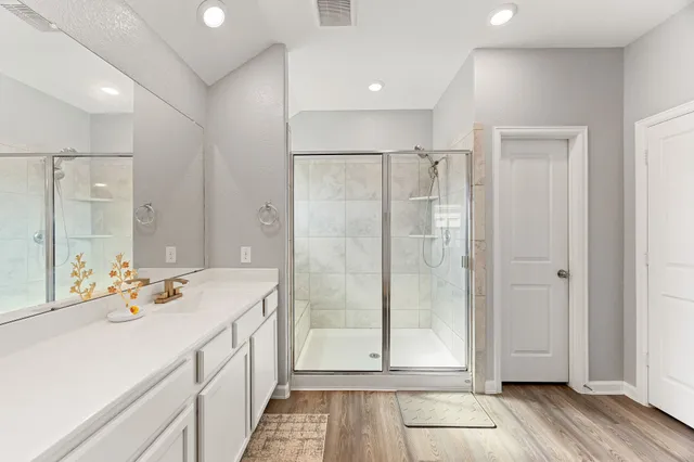 a bedroom with a bed and a ceiling fan