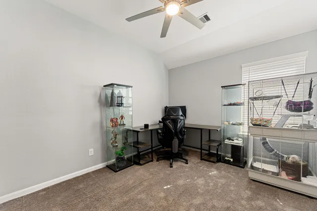 a room with a baby bed dresser and a window