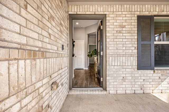a view of a brick house with a outdoor space