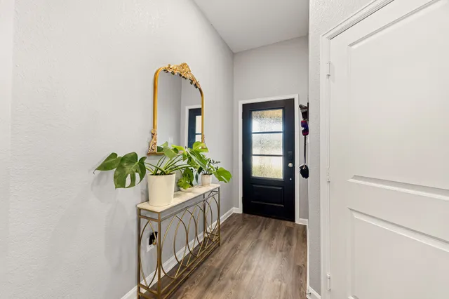 a view of an entryway with wooden floor