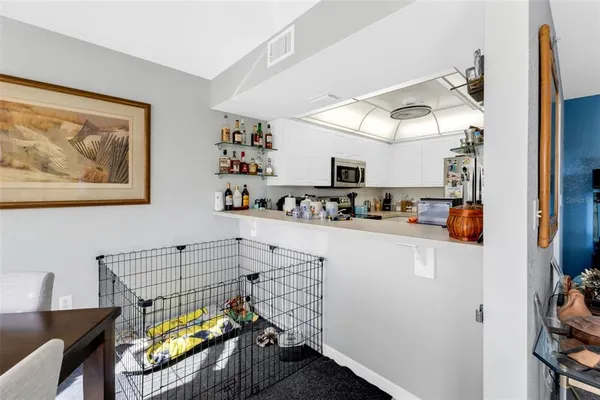 a view of a workspace with furniture and a window