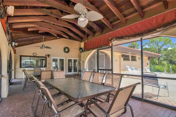 a view of a table and chairs in back yard of the house