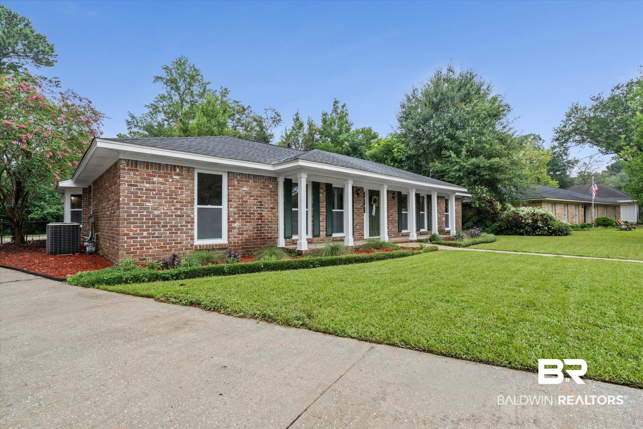 3655 Claridge Road South Mobile, AL 36608 - Photo 3 of 32 Ranch-style home featuring brick siding, covered porch, a front lawn, and roof with shingles