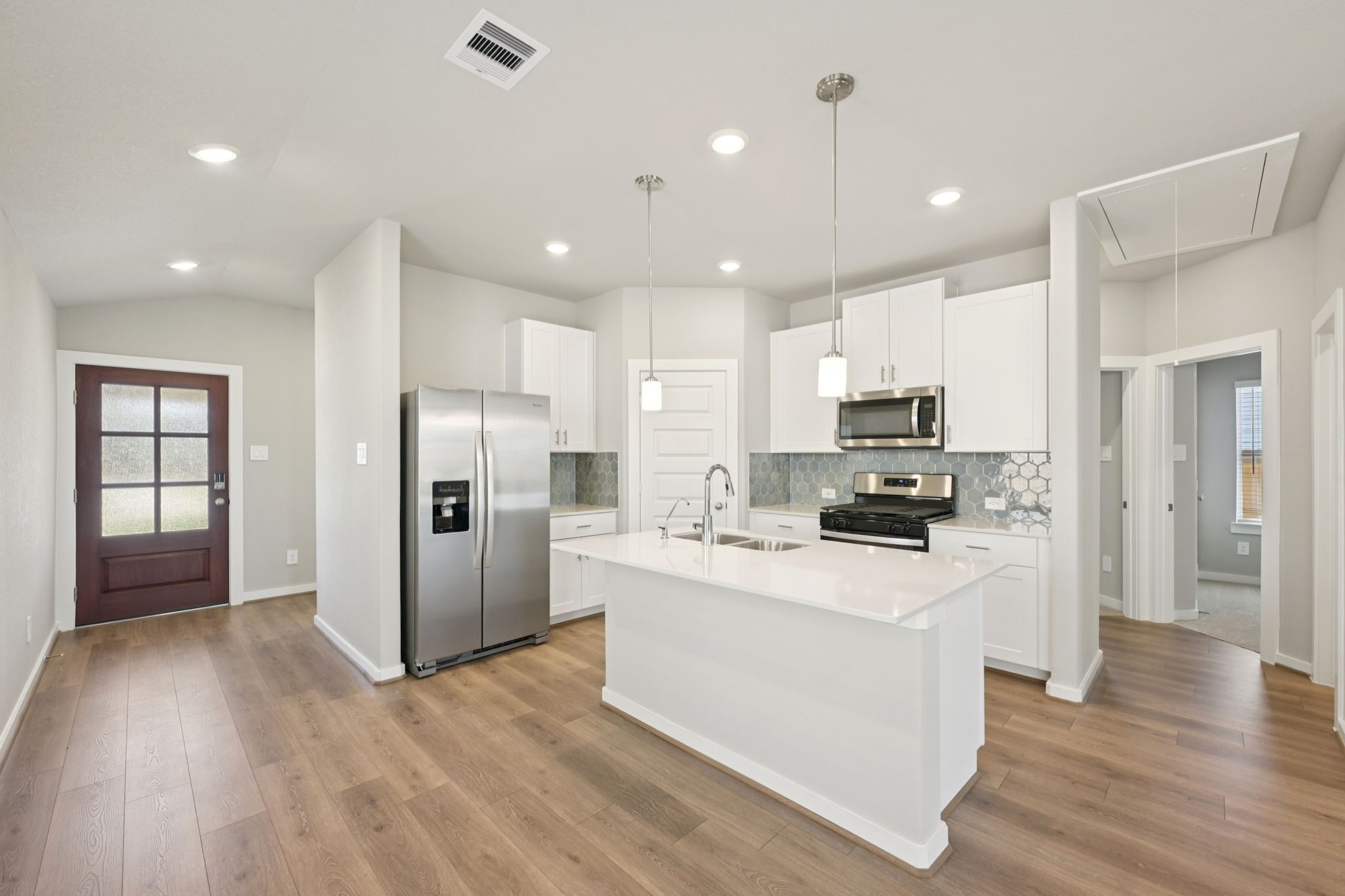 a kitchen with stainless steel appliances a refrigerator stove microwave and cabinets