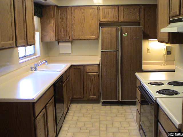 1355 Davidson Way Reno, NV 89509 - Photo 6 of 6 a kitchen with granite countertop a refrigerator and a sink