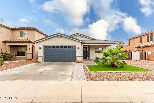 a front view of a house with a yard and garage