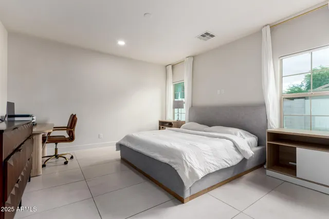 a bedroom with a bed and a desk