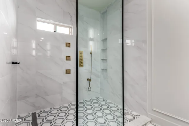 a bathroom with a glass shower door