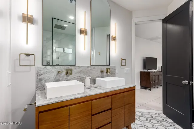 a bathroom with a double vanity sink and mirror