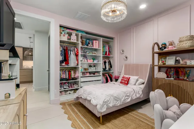 a bedroom with furniture and a book shelf