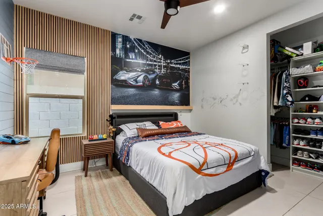 a bedroom with a bed and a television