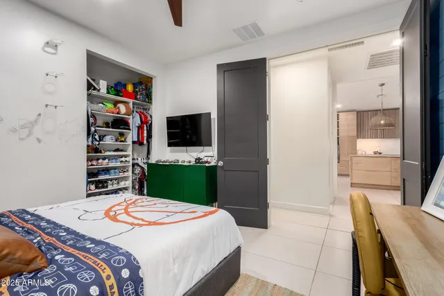 a bedroom with bed couch and window