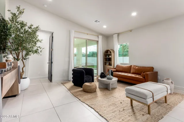a living room with furniture and a potted plant