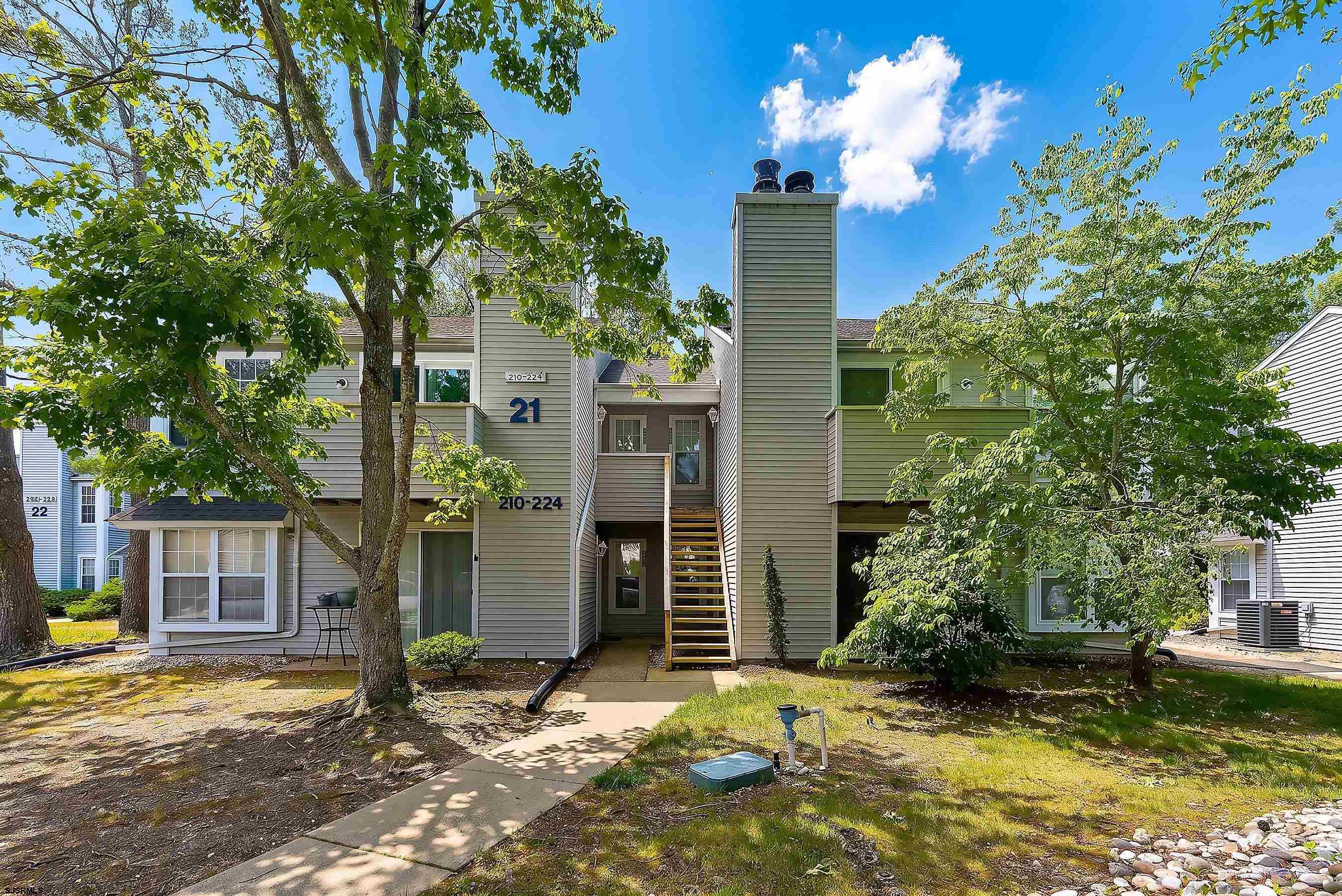 224 Meadow Ridge Road, Unit 224 Smithville, NJ 08205 - Photo 1 of 22 a view of a house with backyard garden and sitting area
