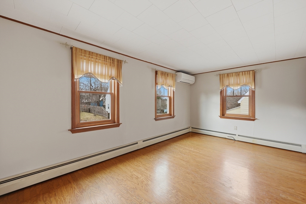 24-26 Watt Road Worcester, MA 01606 - Photo 6 of 41 a view of an empty room with window and wooden floor