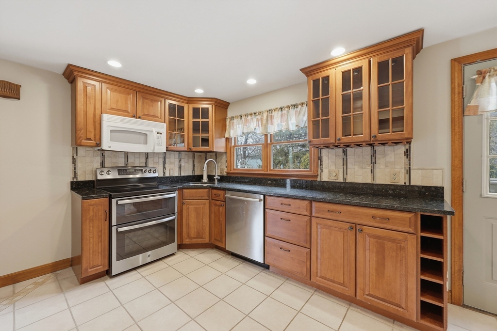 24-26 Watt Road Worcester, MA 01606 - Photo 7 of 41 a kitchen with granite countertop a sink window and cabinets