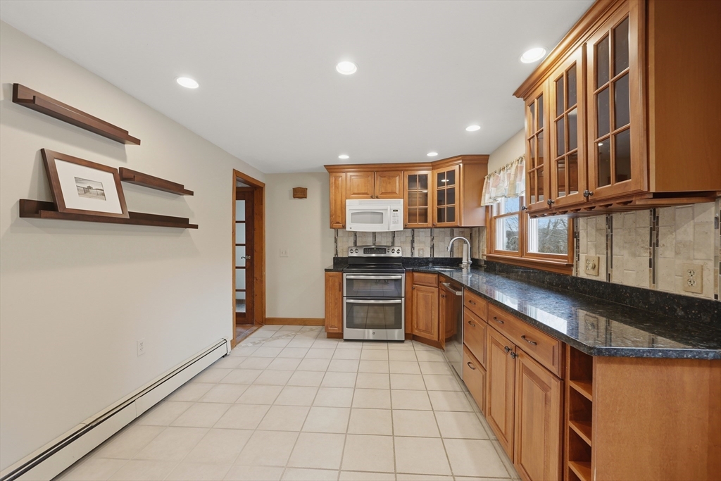 24-26 Watt Road Worcester, MA 01606 - Photo 8 of 41 a kitchen with stainless steel appliances granite countertop a refrigerator and a stove top oven