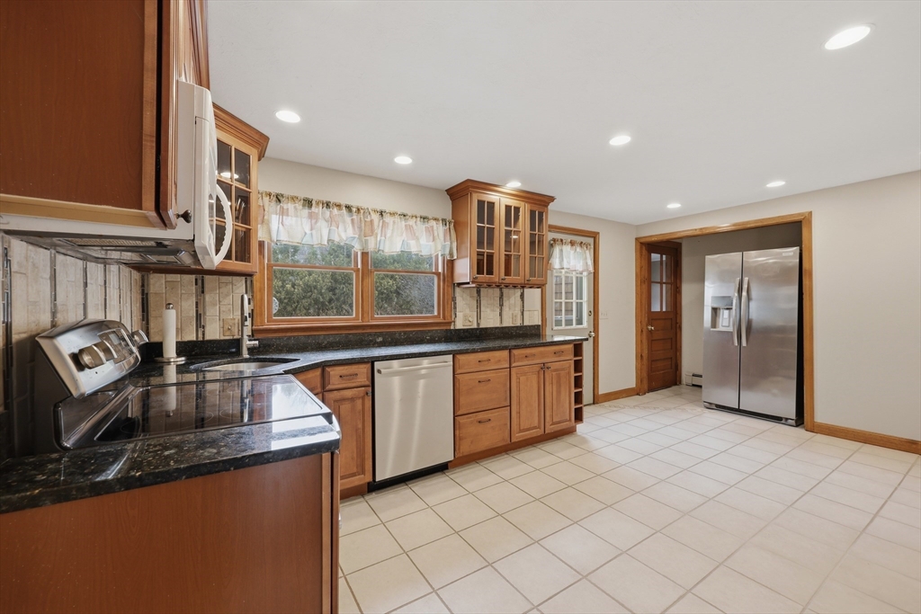 24-26 Watt Road Worcester, MA 01606 - Photo 9 of 41 a kitchen with stainless steel appliances granite countertop a sink and a refrigerator