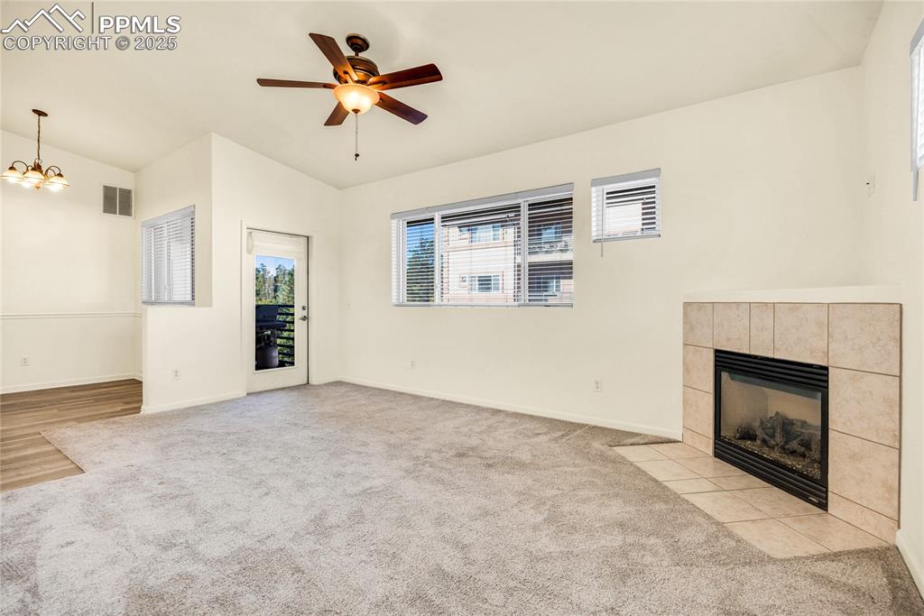 3765 Hartsock Lane, Unit 307 Colorado Springs, CO 80917 - Photo 13 of 37 an empty room with windows and fireplace