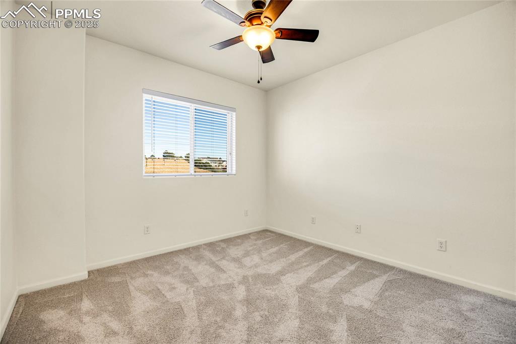 3765 Hartsock Lane, Unit 307 Colorado Springs, CO 80917 - Photo 21 of 37 an empty room with a window and a fan