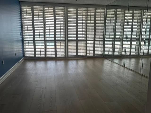 an empty room with wooden floor
