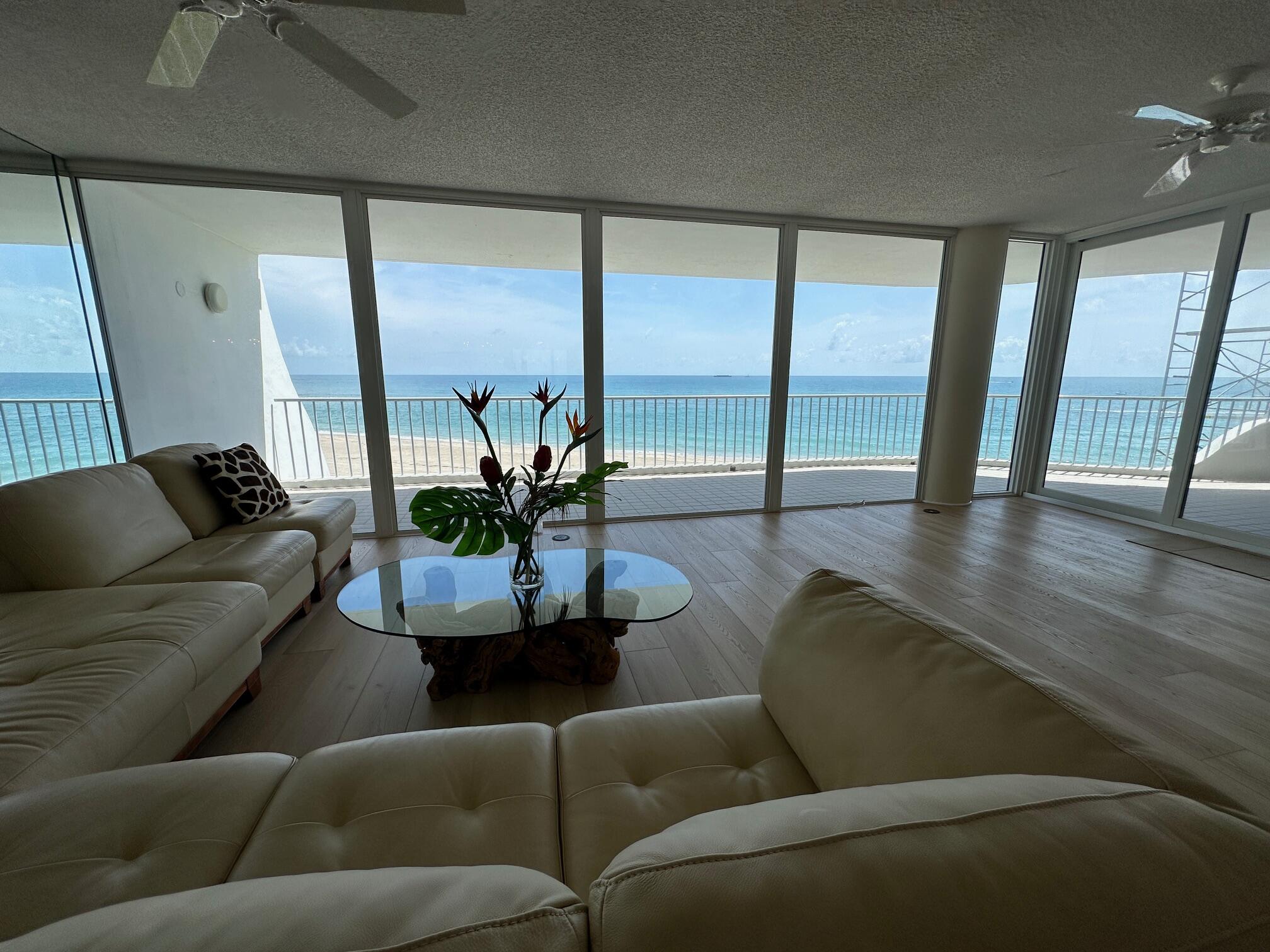 2001 Southeast Sailfish Point Boulevard, Unit 316 Stuart, FL 34996 - Photo 13 of 39 a living room with furniture and a large window