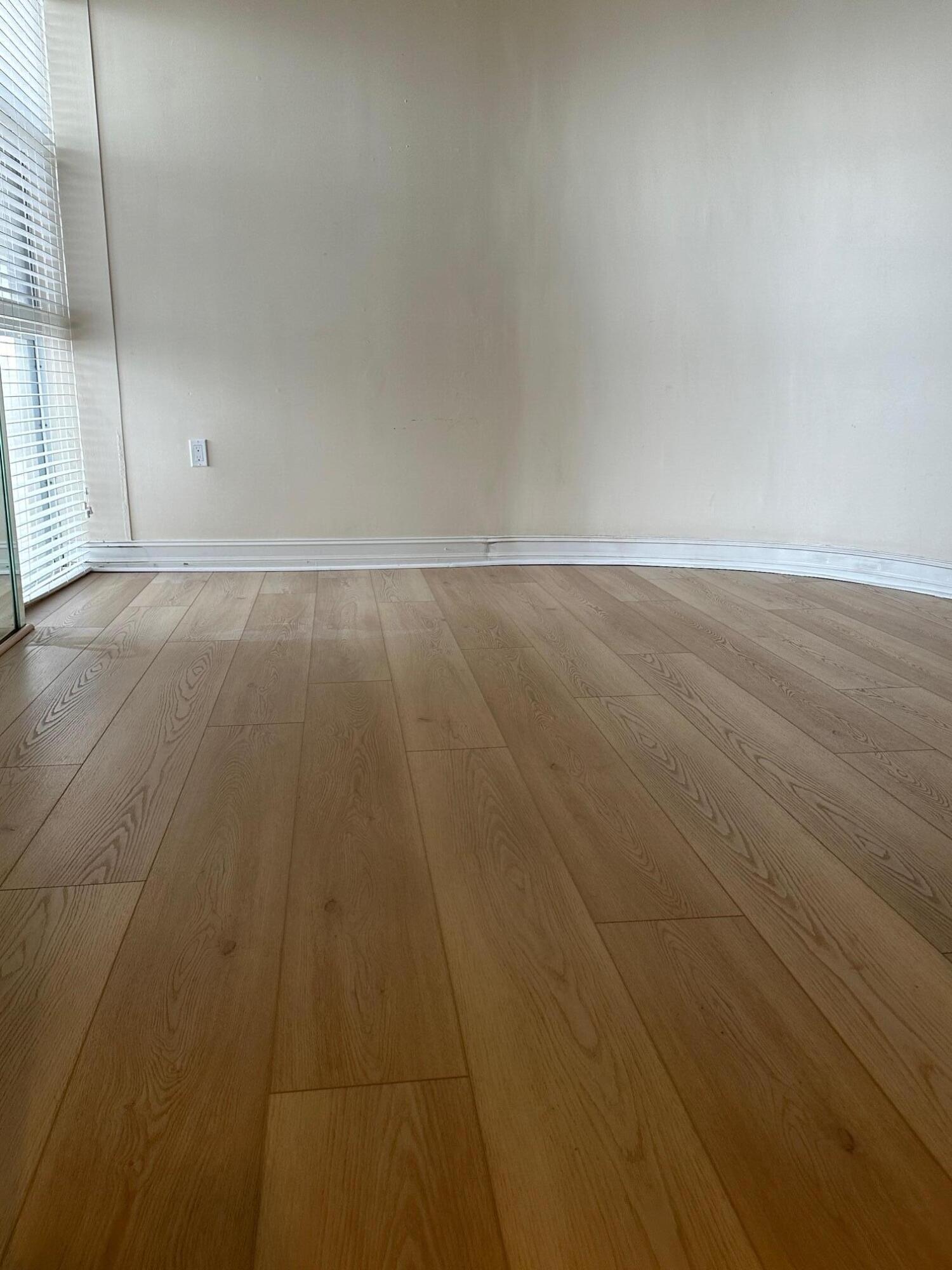 2001 Southeast Sailfish Point Boulevard, Unit 316 Stuart, FL 34996 - Photo 22 of 39 an empty room with wooden floor