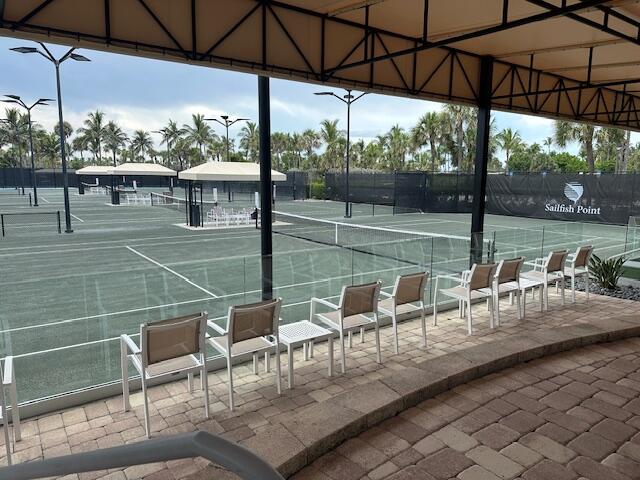 2001 Southeast Sailfish Point Boulevard, Unit 316 Stuart, FL 34996 - Photo 31 of 39 a view of chairs and table in the patio with a lake view